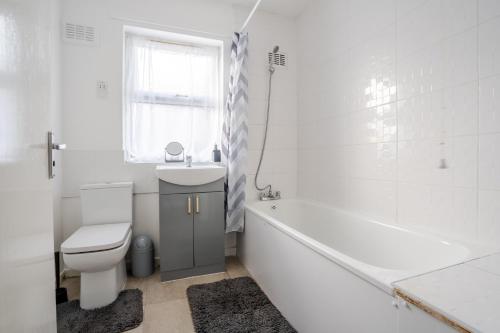 a white bathroom with a tub and a toilet and a sink at Serviced Accommodation Liverpool by Tomla- Free Parking in Liverpool
