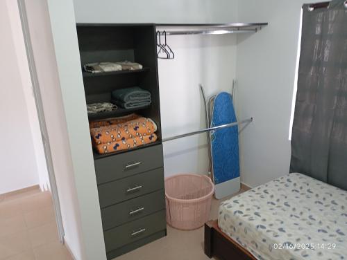 a bedroom with a closet with a bed in it at Casa arcilla clima total Starlink zona Aeropuerto in Villa Juárez