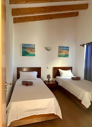 two beds sitting next to each other in a bedroom at Casa Maria Apartments in Santa Maria
