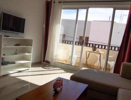 a living room with a view of a balcony at Casa Maria Apartments in Santa Maria