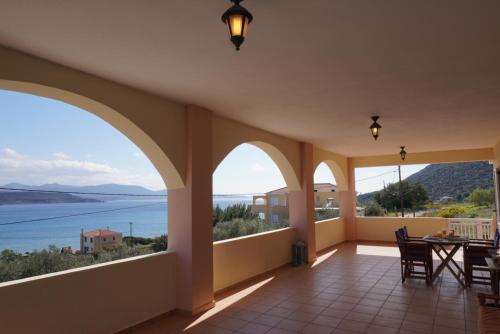 a large room with a view of the water at Seaside Serenity in Karavostásion