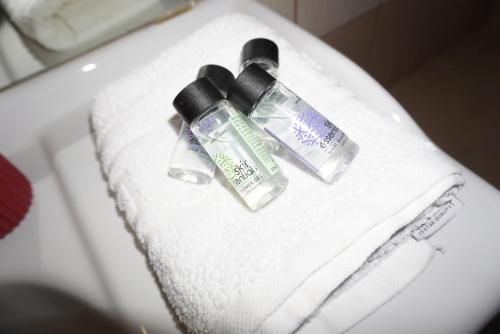 two bottles ofodorizers sitting on top of a towel at Seaside Serenity in Karavostásion