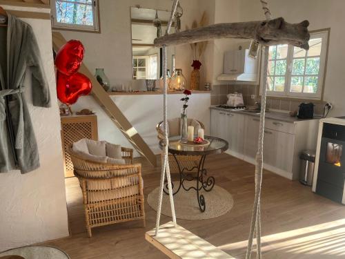 a living room with a swing and a kitchen at Maison du bonheur in Mouans-Sartoux