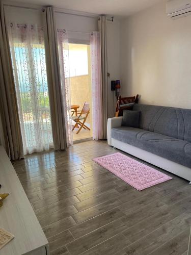 a living room with a couch and a rug at Da Marta Appartamento VISTA MARE MOZZAFIATO ISOLA ROSSA in Cascabraga
