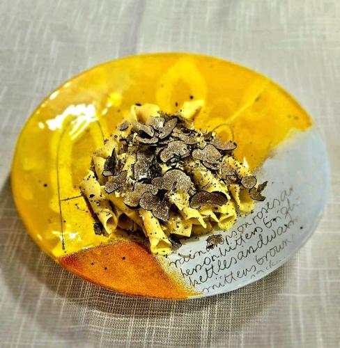 a yellow piece of food on a table at Rooms Konoba Pjero in Buje
