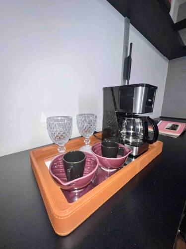 a tray with three glasses and a coffee maker on it at Renoir - Av Barão Homem de Melo nº 4520 - pegar nº do flat no chat após reserva in Belo Horizonte