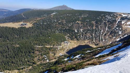 an aerial view of a mountain with snow and trees at Apartmán U Bejka in Hořejší Vrchlabí