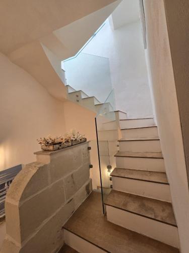 a room with stairs and a large window at Amelie - Charming Townhouse in the heart of Rabat in Rabat