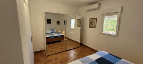 a bedroom with a glass shower with a bed in it at Sítio da Cornucópia Casa Principal in Moncarapacho