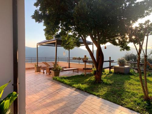 a patio with benches and a view of the water at Agriturismo La Terrazza su Farfa in Castelnuovo di Farfa