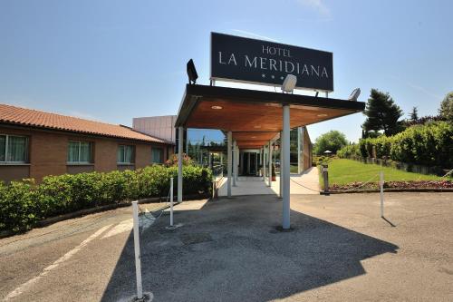 a sign that reads hotel la meridianiana in front of a building at La Meridiana Bleisure Hotel in Perugia