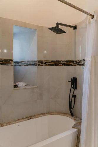 a bathroom with a bath tub and a shower at Casa Amigos , entire 3 bedroom ground floor condo at Playa Grande Condominium Resort in El Coco