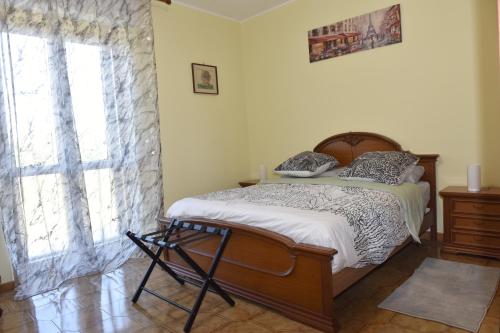 a bedroom with a bed and a large window at Il Casale Delle Rose in Colle Micotti