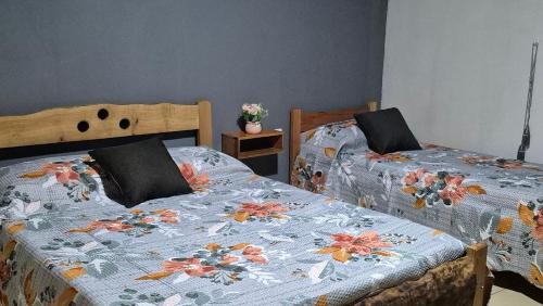 a bedroom with two beds with a quilt on them at Departamentos Puerto Esperanza in Puerto Esperanza