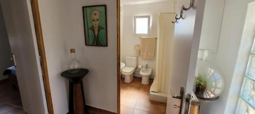 a small bathroom with a toilet and a sink at Sítio da Cornucópia Casa Principal in Moncarapacho