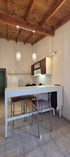 a kitchen with a table and chairs in a room at Departamento amoblado quincenal, mensual in Neuquén