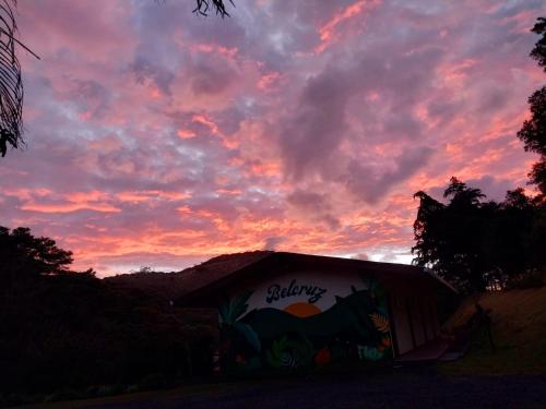 a building with a painting on it under a sunset at Belcruz family lodge in Monteverde Costa Rica