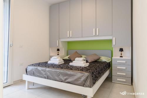 Ένα ή περισσότερα κρεβάτια σε δωμάτιο στο Condominio Gavioli - InVacanza