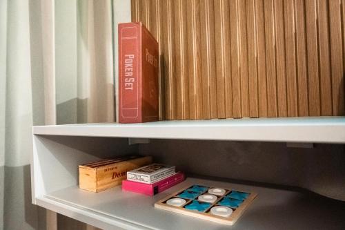 a shelf with a book and boxes on it at Seaside Escape at Luquillo Beach - Palma Luxe Studio in Luquillo