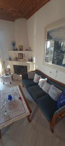 a living room with a couch and a table at Tsitsinakis Traditional Home in Hydra