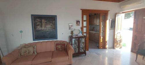 a living room with a couch and a door at Tsitsinakis Traditional Home in Hydra