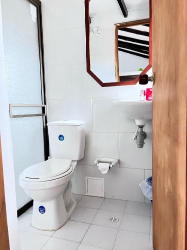 a bathroom with a toilet and a sink at Hospedería Villa Lucía in Villa de Leyva