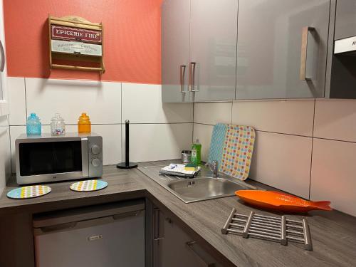une cuisine avec un évier et un micro-ondes dans l'établissement Studio 