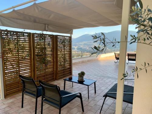a patio with chairs and a table with a view at Agriturismo La Terrazza su Farfa in Castelnuovo di Farfa