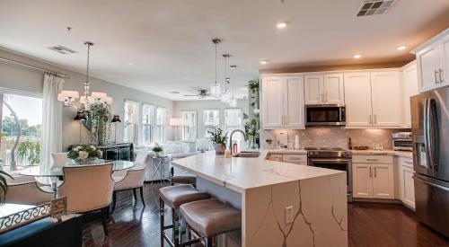 a kitchen with white cabinets and a table with chairs at Queen Creek #151 Chandler in Chandler