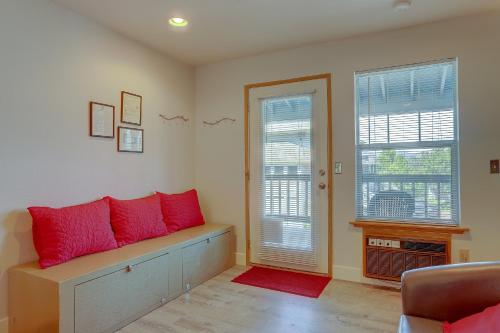a living room with red pillows on a bench at Beautiful Condo River Views Steps to Downtown Heart of Hood River 4263 in Hood River