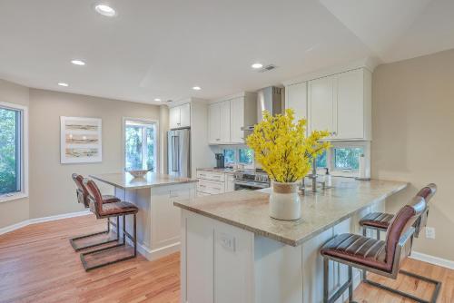 a kitchen with white cabinets and a counter with yellow flowers at 3032 Marsh Haven in Johns Island