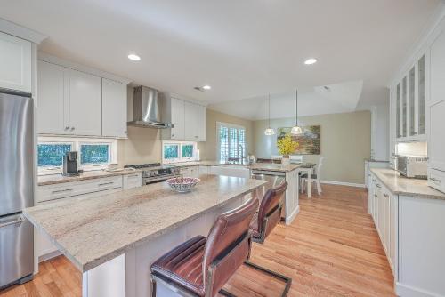 a large kitchen with white cabinets and a large island at 3032 Marsh Haven in Johns Island