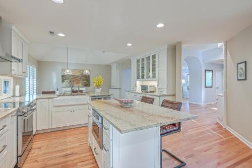 a large kitchen with white cabinets and a large island at 3032 Marsh Haven in Johns Island