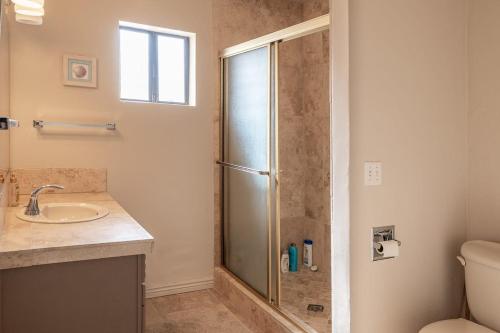 a bathroom with a shower and a sink at Moovalya Keys Riverfront Room for all in Parker