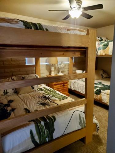 a bedroom with two bunk beds and a ceiling fan at Moovalya Keys Riverfront Room for all in Parker