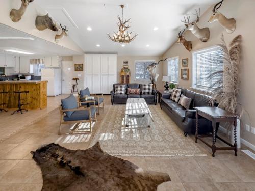 a living room with a couch and a table at Mountain Meadow Retreat near Park City in Peoa