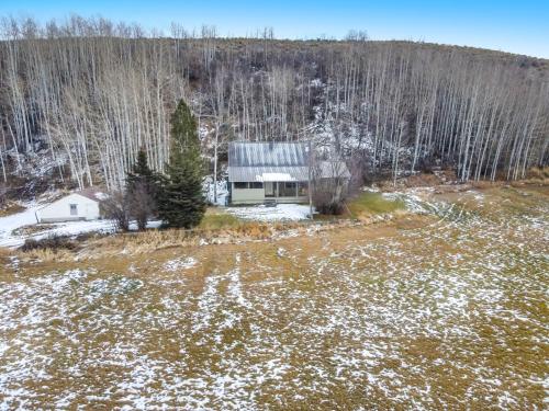 an aerial view of a house in the woods at Mountain Meadow Retreat near Park City in Peoa