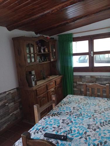 a bedroom with a bed and a table and a window at Casaluma in Jose De San Martin