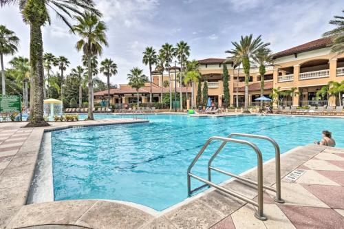a swimming pool at a resort with palm trees at Cozy Orlando Resort Condo 4Mi from Disney in Orlando