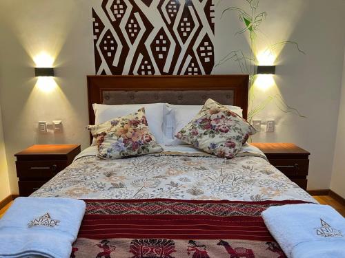 a bedroom with a bed with two pillows on it at Casa Antade Cusco in Cusco