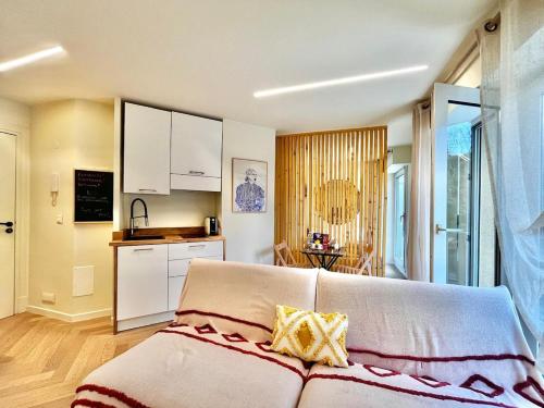 a living room with a couch and a kitchen at Studio Moderno Lungo Mare-ideale inverno in Menton