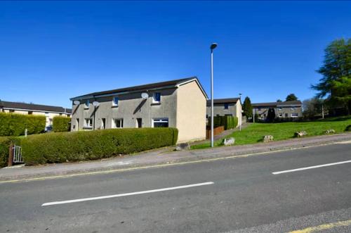 a building on the side of a road next to a street at Fort William - Highland holiday home in Fort William