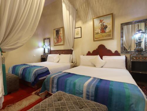 Postel nebo postele na pokoji v ubytování Riad Villa Elgada