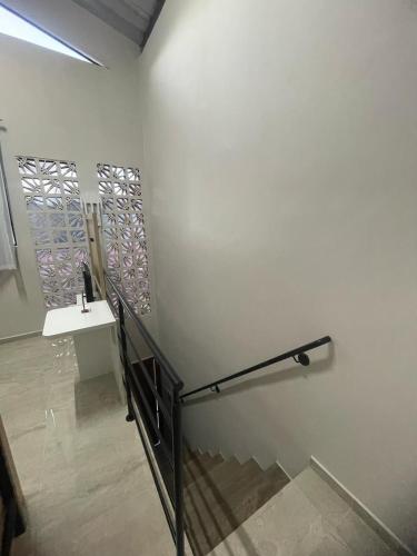 a room with a staircase and a white wall at Brisa - Praia da Pipa in Pipa