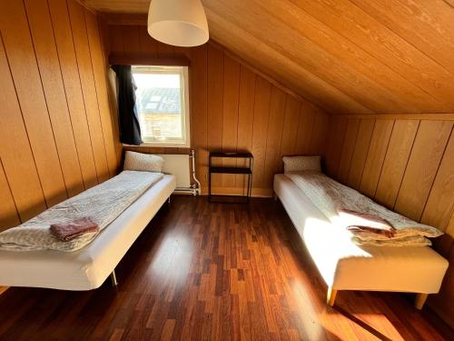 a room with two beds and a window at Charming Guest House in Oslo City 4 in Oslo