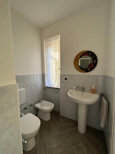 a bathroom with a toilet and a sink at Rural Apartment 44 in Alghero
