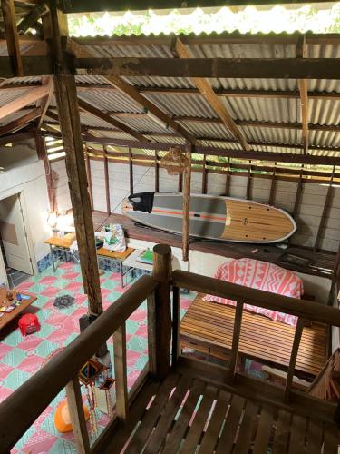 a room with a surfboard on top of a house at Kom buds garden in Ko Yao Noi