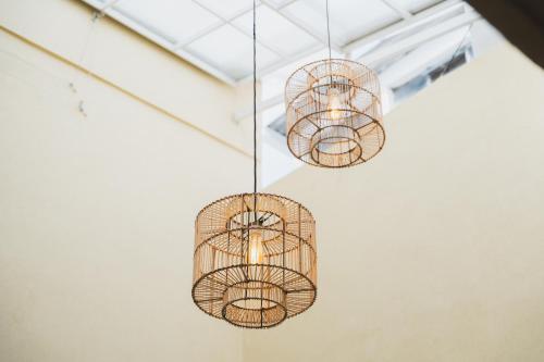 a group of cages hanging from a ceiling at Casa Serena in Ibagué