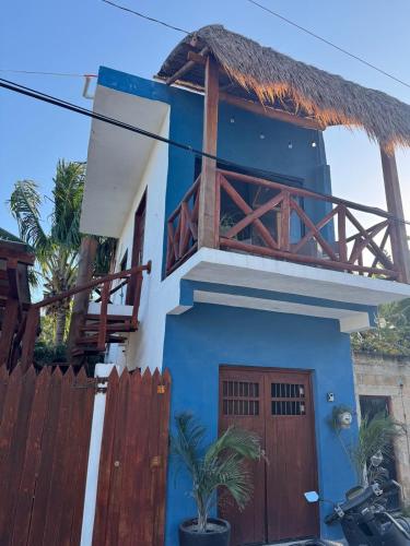 a blue and white house with a wooden fence at Departamento New 2 in El Cuyo