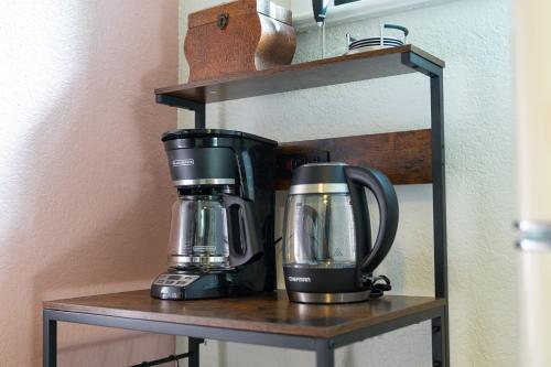 a coffee maker and a blender on a shelf at Historic Orlando Casita Love Apt A with backyard in Orlando